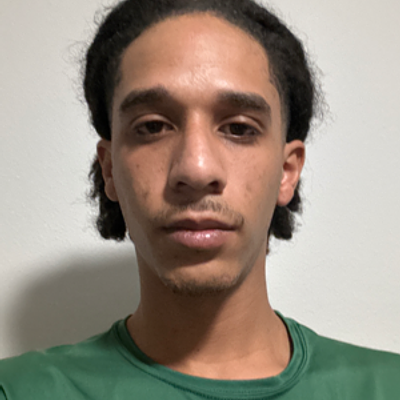 Smiling GreenPal vendor with dark hair and beard