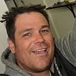 Professional headshot of a smiling man