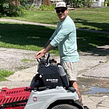Professional landscaper mowing a green residential lawn