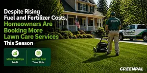 A lawn care professional mows a vibrant green lawn in front of a suburban home.