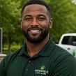 Smiling Black man in dark polo shirt, headshot of a lawn care vendor