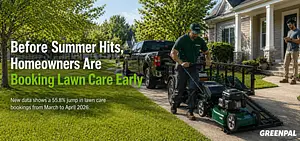 Lawn care worker unloading a mower from a trailer in front of a suburban house.