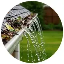 Rainwater overflowing from a clogged gutter onto a yard in Oceanside, CA