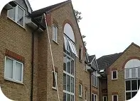 Gutter cleaning crew servicing a multi-unit community building in Oceanside, CA