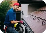 Professional cleaning gutters on a single-family home in Oceanside, CA
