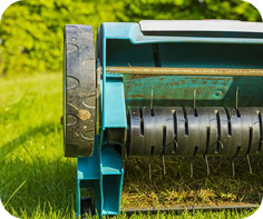 Spike aerator equipment on grass—lawn aeration cost and options in Chicago