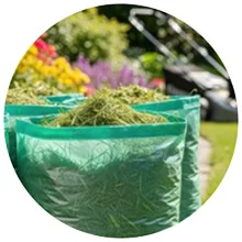Bagging hedge clippings after trimming along a front walkway in Logan, UT
