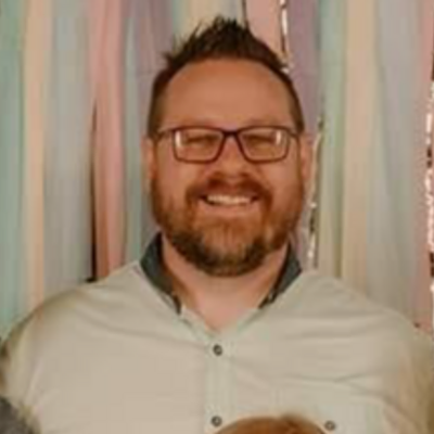 Headshot of a smiling man with a beard for landscaping