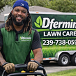 Smiling professional landscaper with a beard wearing a dark polo shirt